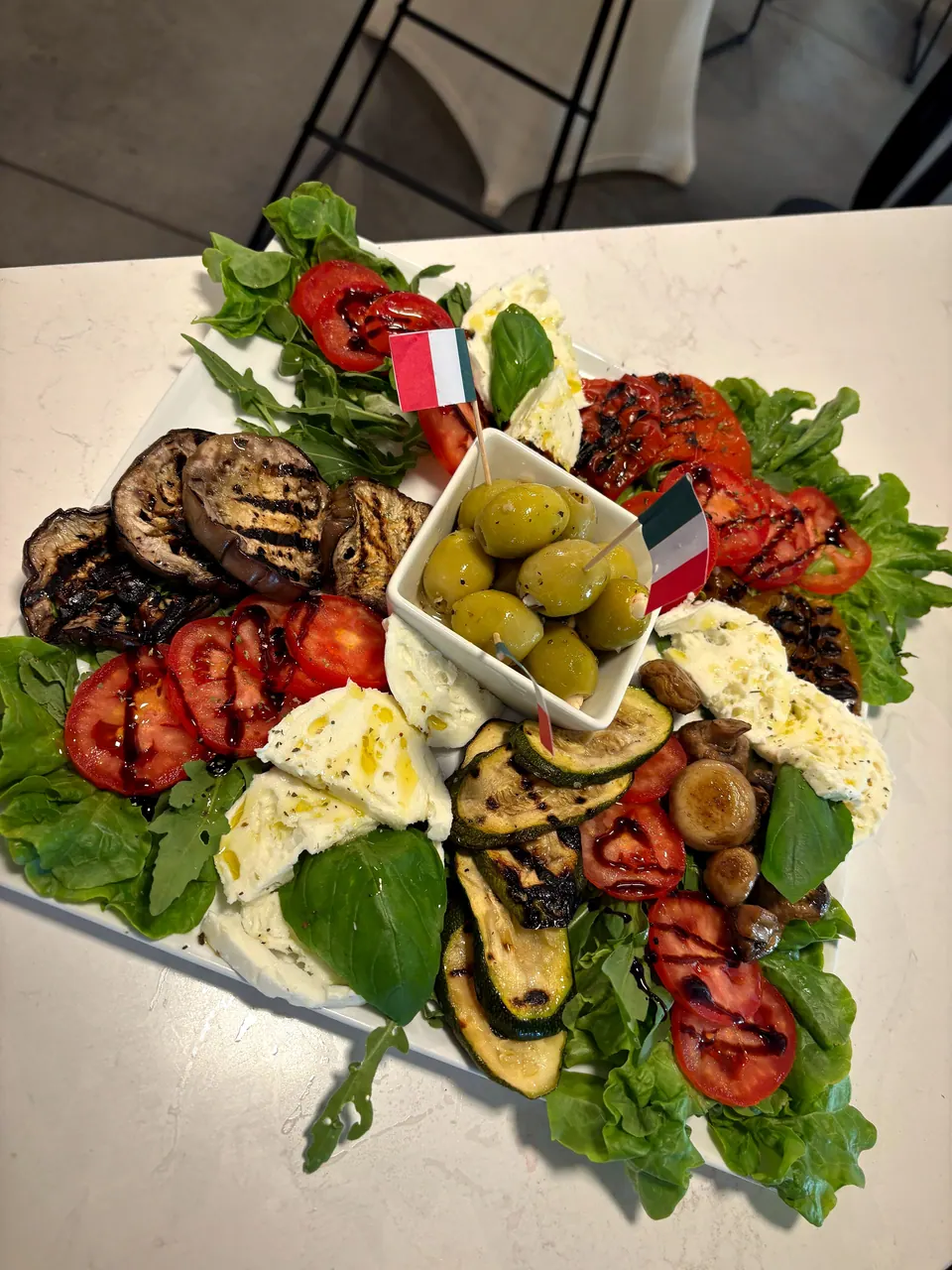 Antipasti-Platte mit gegrilltem Gemüse, Mozzarella, Tomaten und Oliven